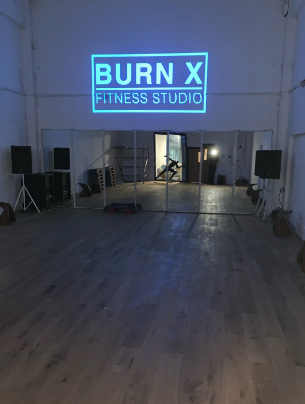 gobo lights show the gym fitness studio brand name in light blue
